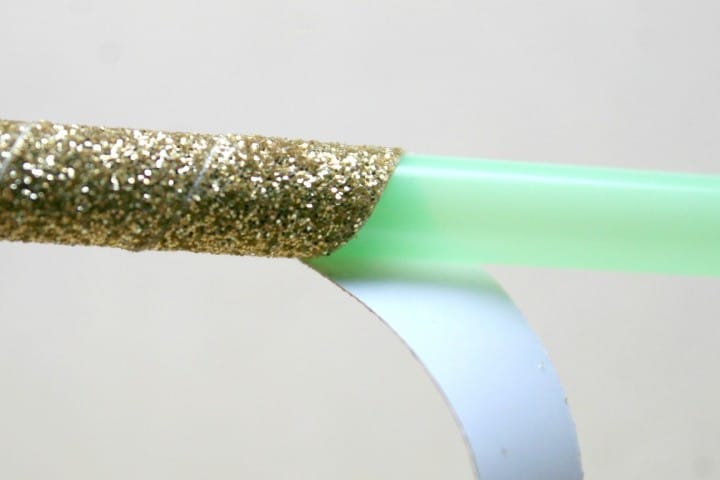 dear lizzy fifth & frolic glitter tape being wrapped on a green straw