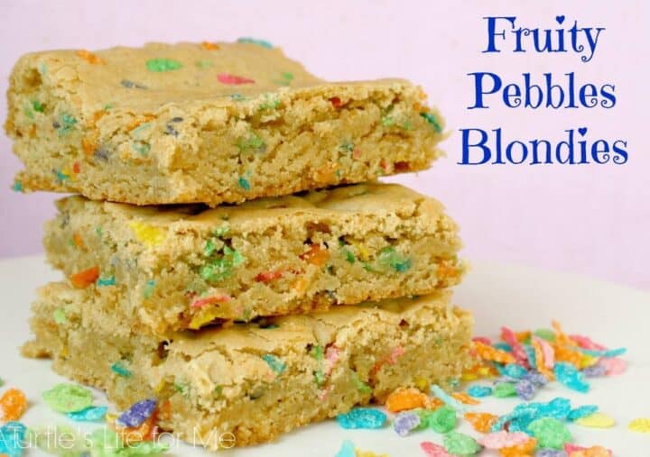 A stack of homemade fruity pebble blondies on a white plate with a pink background. The text says Fruity Pebble Blondies