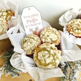 2 muffin gift baskets packaged with tissue paper and a tag that says, 