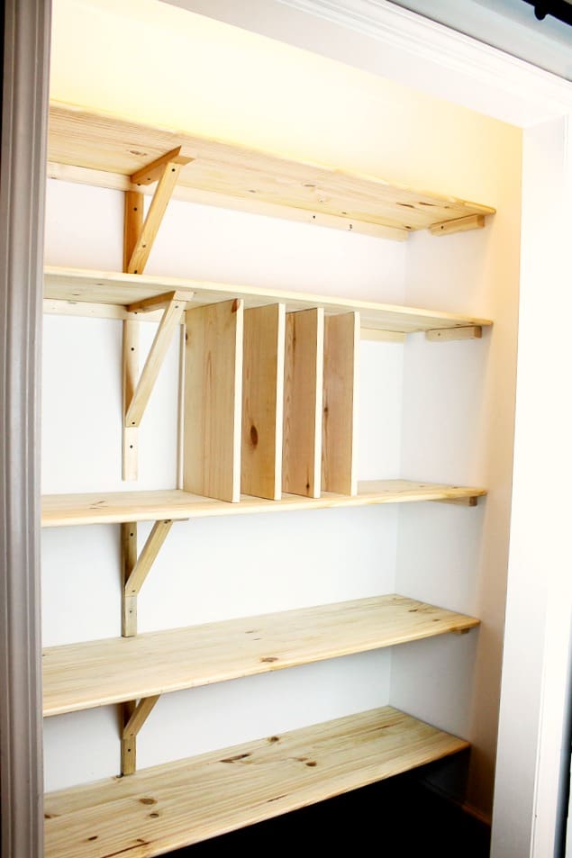 An in process DIY Pantry remodel showing pantry shelves and cookie sheet dividers