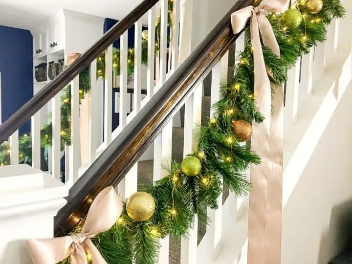 how to make faux evergreen staircase garland with LED Christmas lights with ribbons
