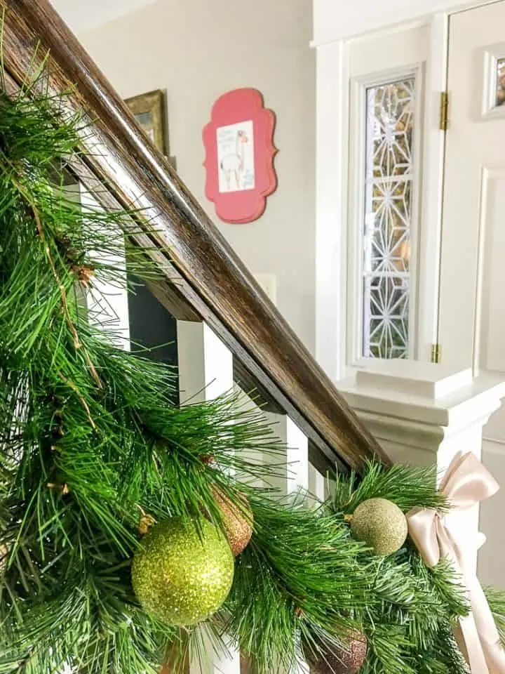 how to make faux evergreen staircase garland with copper LED Christmas lights