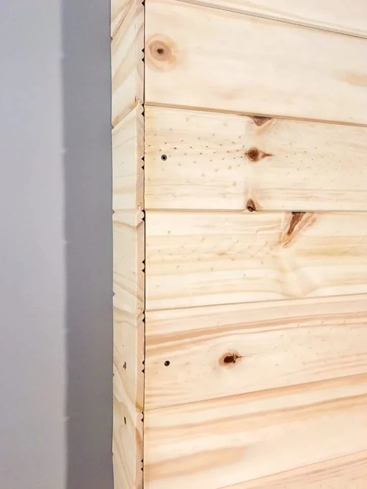 Installing side pieces on a DIY wood pallet wall