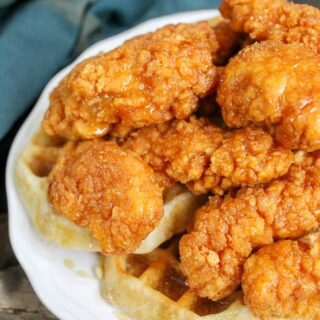 crispy chicken and waffles with honey and maple syrup drizzle