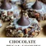 A pinterest pin with an image of a batch of chocolate pecan cookies. The Text says Chocolate Pecan Cookies with a Kiss