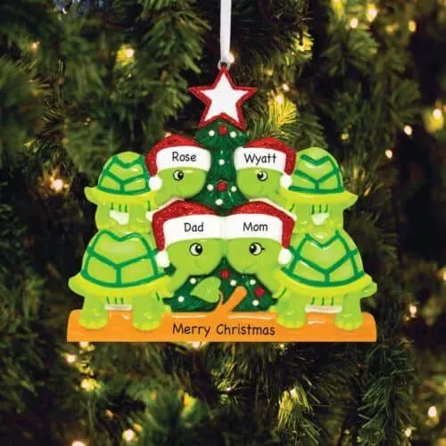A christmas ornament featuring 4  ceramic turtles that make up a turtle family wearing Santa hats.