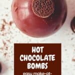 A Pinterest Pin with a close up photograph of a milk chocolate hot chocolate bomb with a mini oreo on top against a white counter. The text says Hot Chocolate Bombs easy make at home recipe