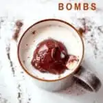 A Pinterest Pin with a birds eye photo of a hot chocolate bomb melting in a mug of hot milk with mini oreos coming out of the chocolate. The text says Hot Chocolate Bombs