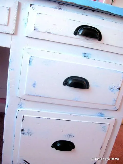 A final photo of a DIY desk project shows distressed desk drawers in white and blue