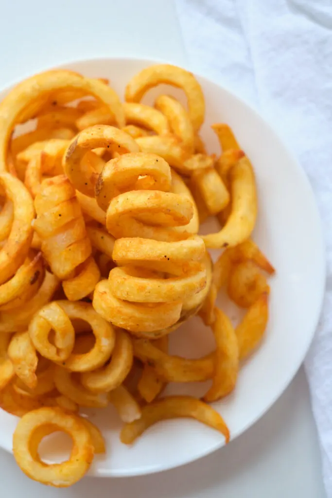 Cooked curly fries on a plate