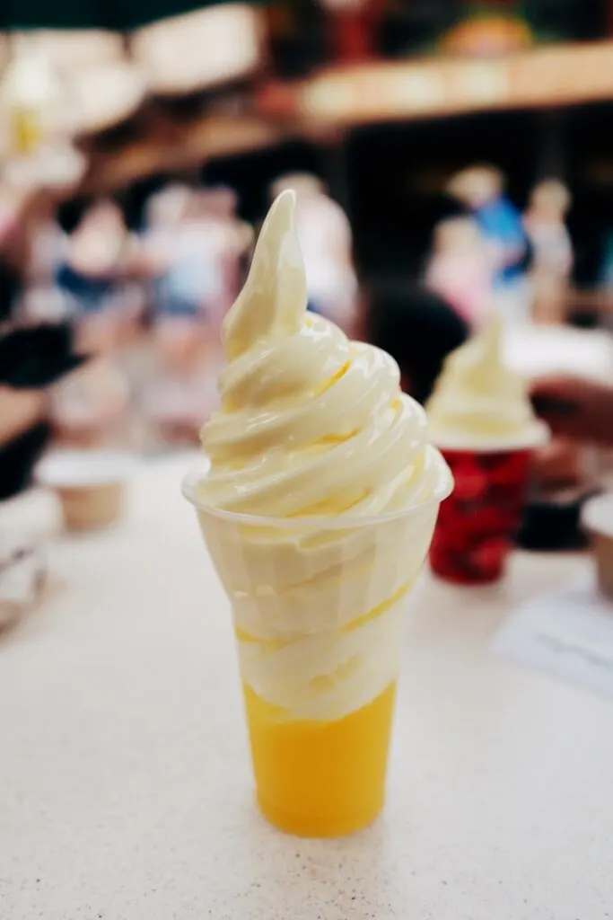 A Disney Dole Whip on a table with a blurred background