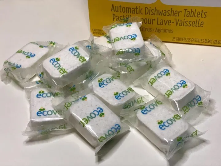Individually wrapped Ecover dishwasher tablets scattered on a table