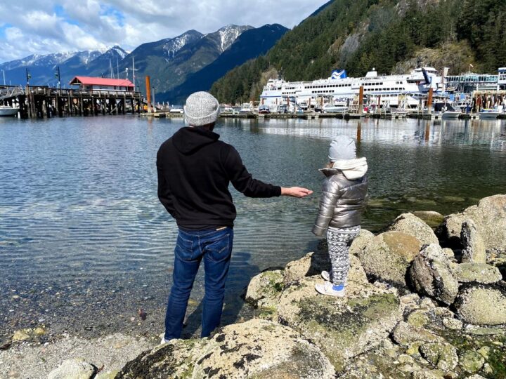 A father and daughter look at a BC Ferries ferry docked in Horseshoe Bay, West Vancouver