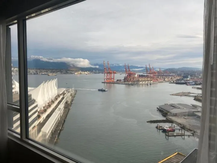 View out the window of a room at the Fairmont Waterfront in Vancouver, BC, of Canada Place in the foreground and North Vancouver in the background